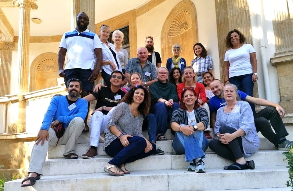 Train the Trainer participants on the steps of a historic building in Cyprus