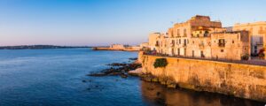 Panoramic photo of Ortigia Old City at sunrise, with Ortigia Castle (Castello Maniace, Castle Maniac
